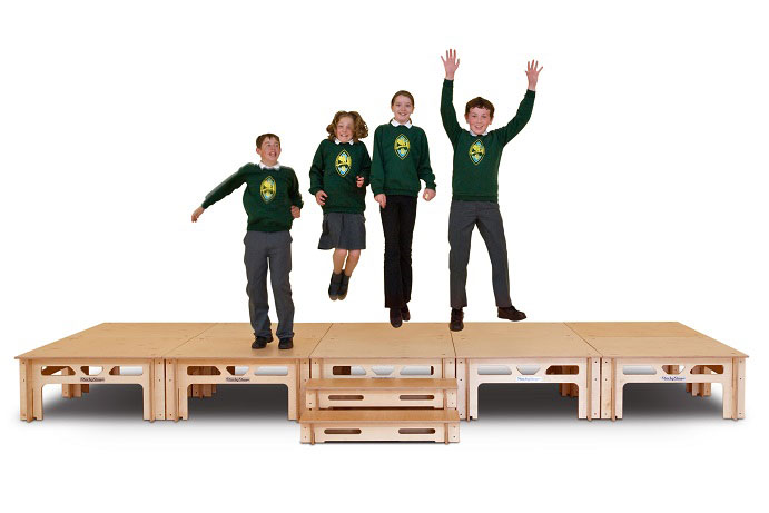 Children jumping on a StackaStage stage for schools